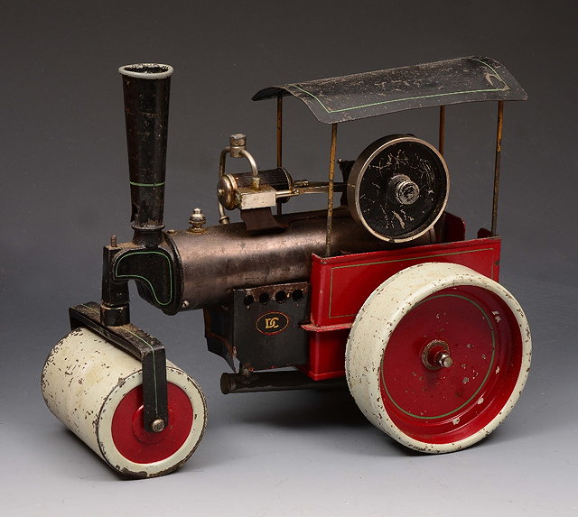 Appraisal: AN ANTIQUE PAINTED TIN MODEL of a steam roller labelled