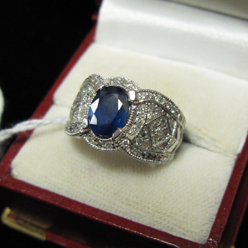 Appraisal: BLUE SAPPHIRE DIAMOND AND FOURTEEN KARAT WHITE GOLD RING The