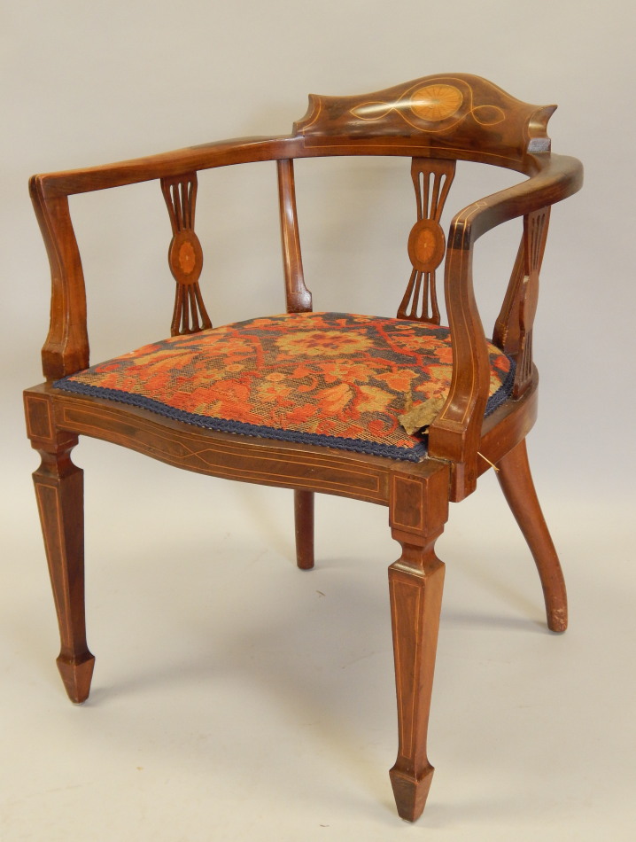 Appraisal: An Edwardian mahogany and marquetry tub shaped chair with a