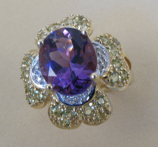 Appraisal: AMETHYST AND FOURTEEN KARAT GOLD RING centering an oval-cut purple