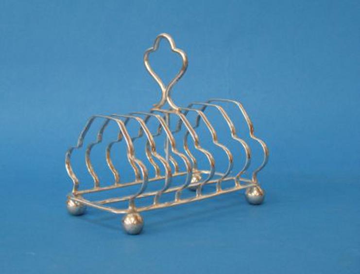 Appraisal: AN EDWARDIAN SEVEN BAR TOAST RACK with a central loop