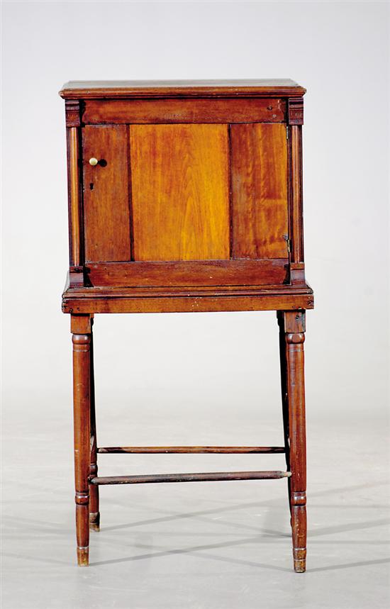 Appraisal: American walnut cabinet on stand late th century molded top