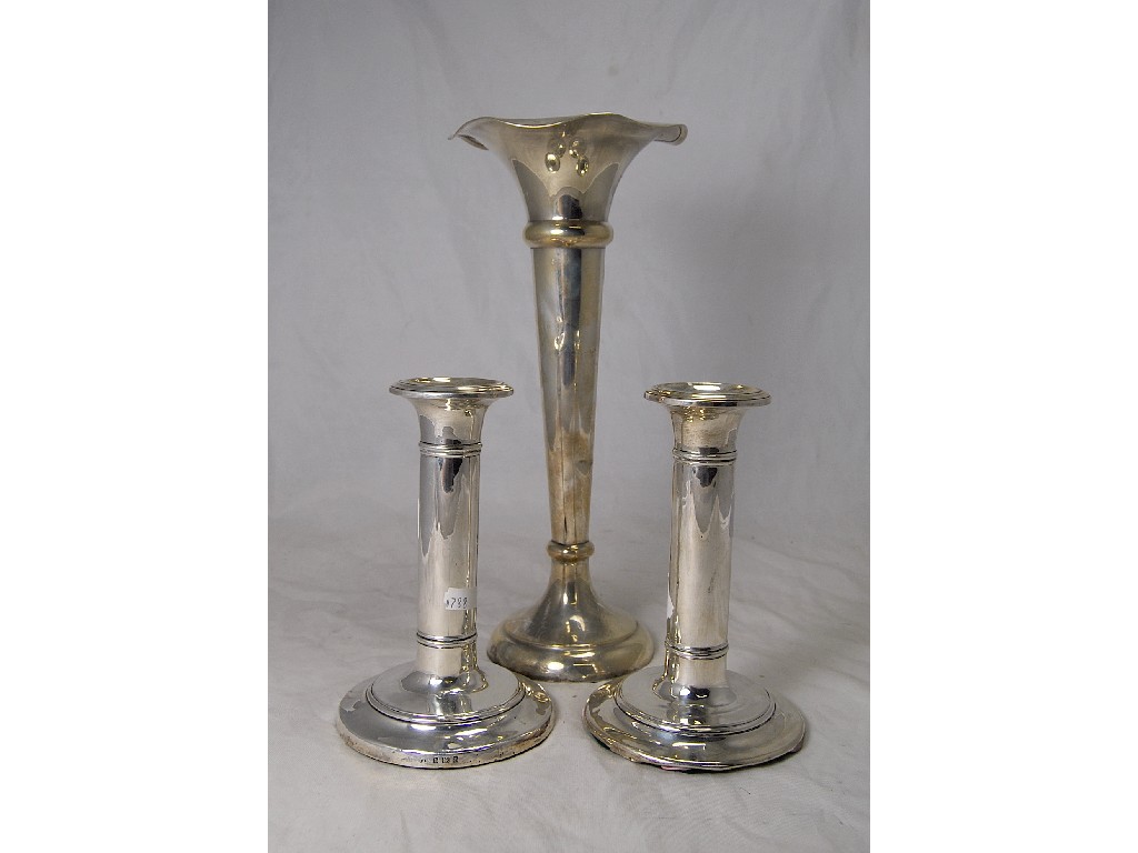 Appraisal: Pair of silver reeded filled candlesticks approx cm high to