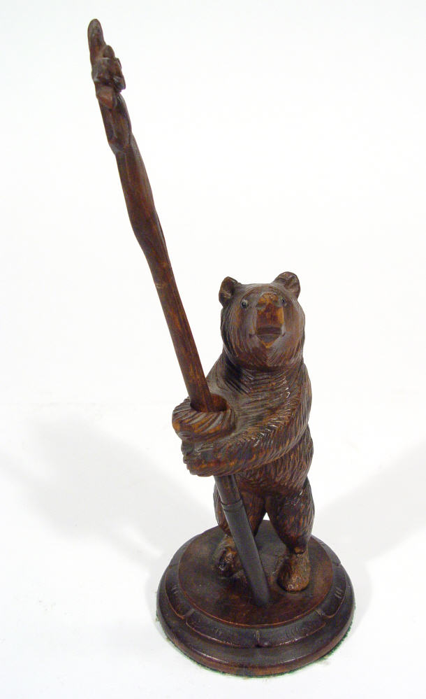 Appraisal: Carved Black Forest bear with outstretched arms clutching a floral