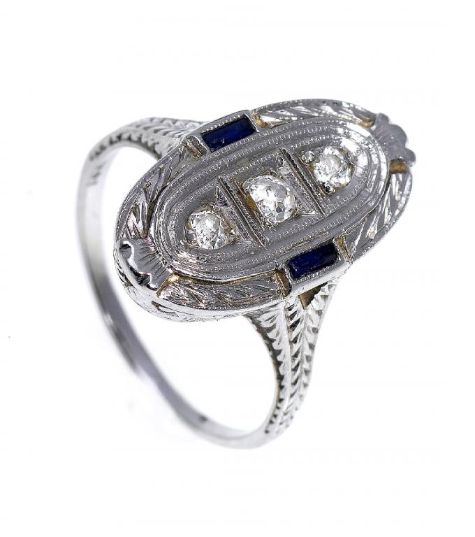 Appraisal: A SAPPHIRE AND DIAMOND RING the oval tablet with three