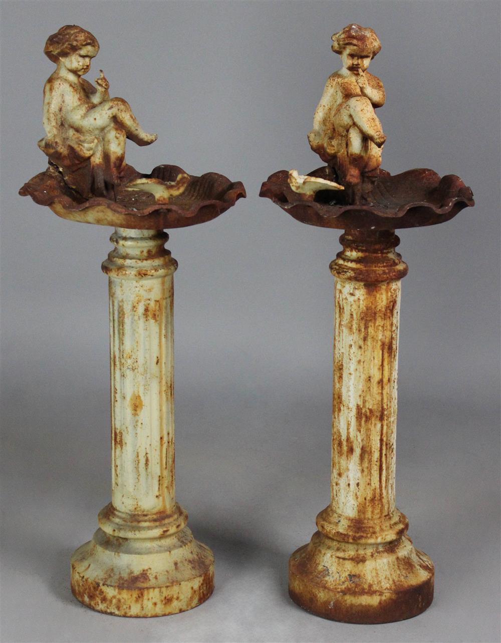 Appraisal: PAIR OF CAST IRON BIRD BATHS WITH PUTTI AND BIRDS