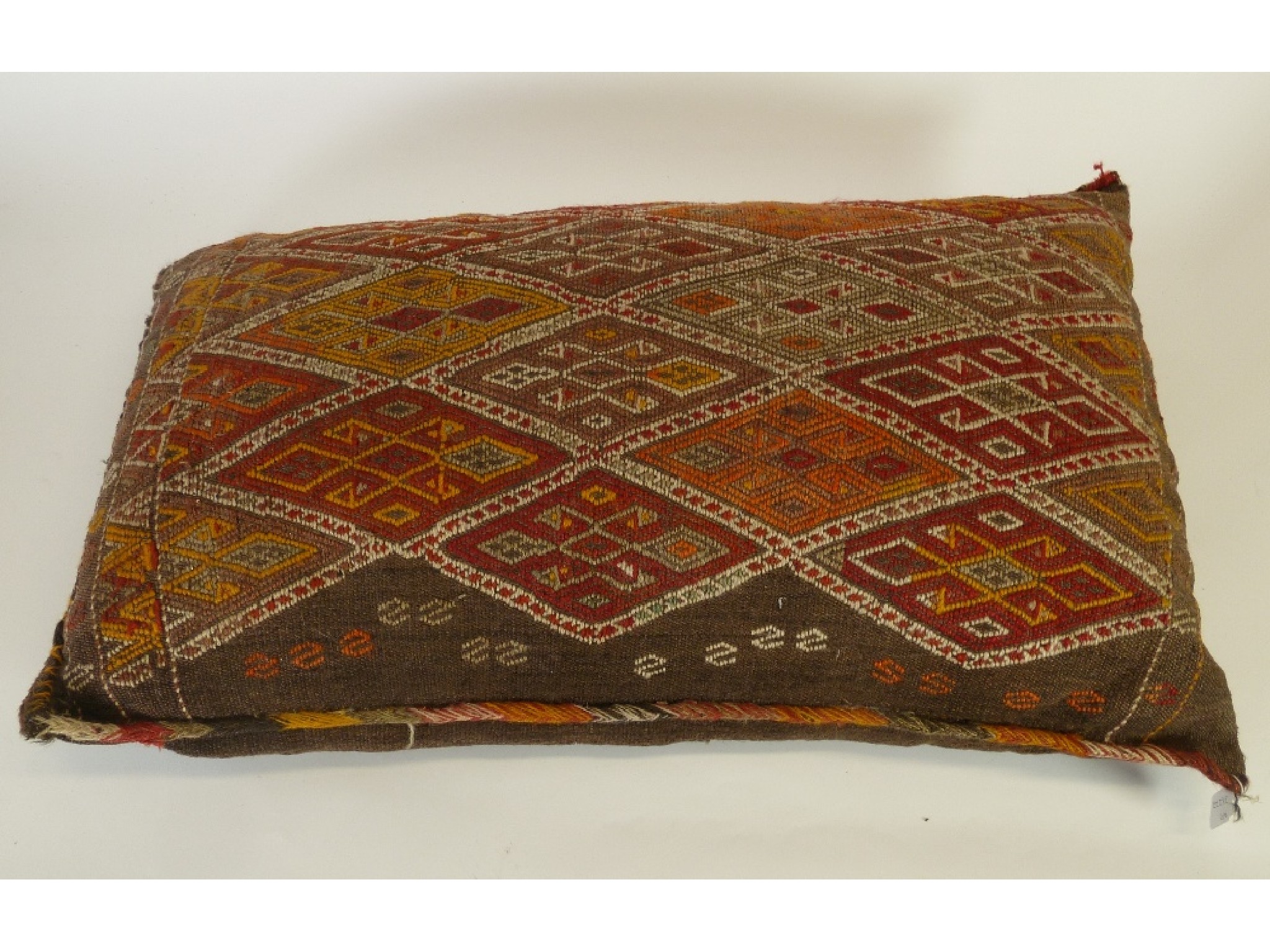 Appraisal: THREE EASTERN LARGE OBLONG CUSHIONS covered in Turkoman flat weave