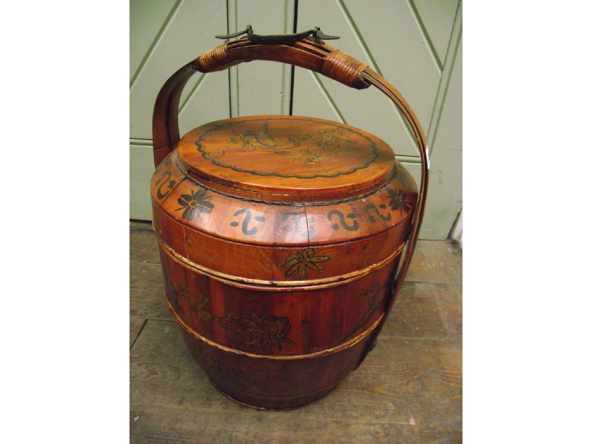 Appraisal: A Chinese fruitwood three tier basket with loop handle applied