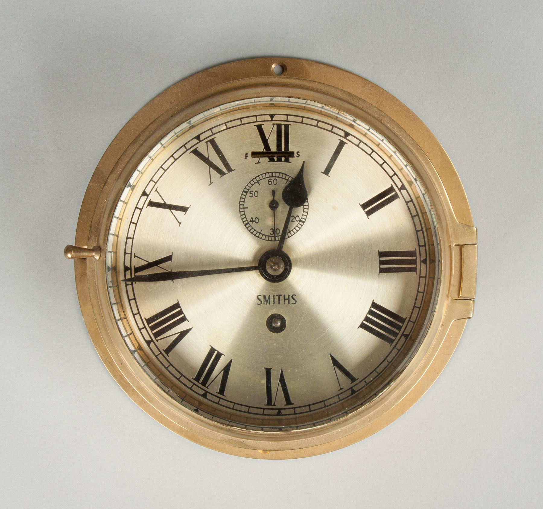 Appraisal: Smiths Brass Ship Clock With silver engraved dial Balance wheel