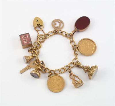 Appraisal: A gold charm bracelet The ct gold curb bracelet mounted