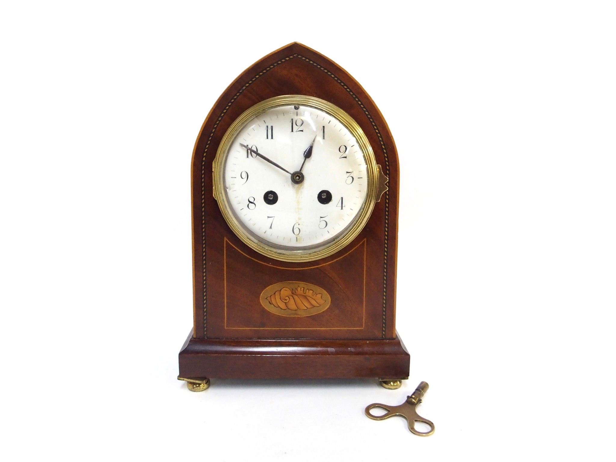 Appraisal: An Edwardian mantel clock with inlaid shell patera