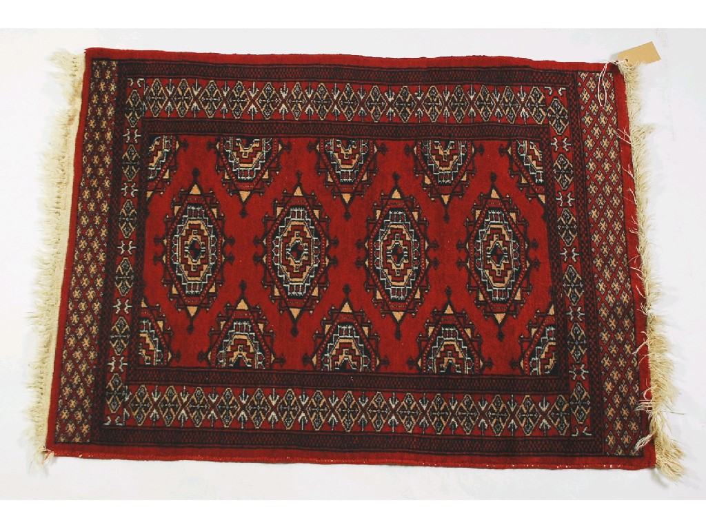 Appraisal: PAKISTAN BOKHARA SILKY PILE RUG with three rows of diamond