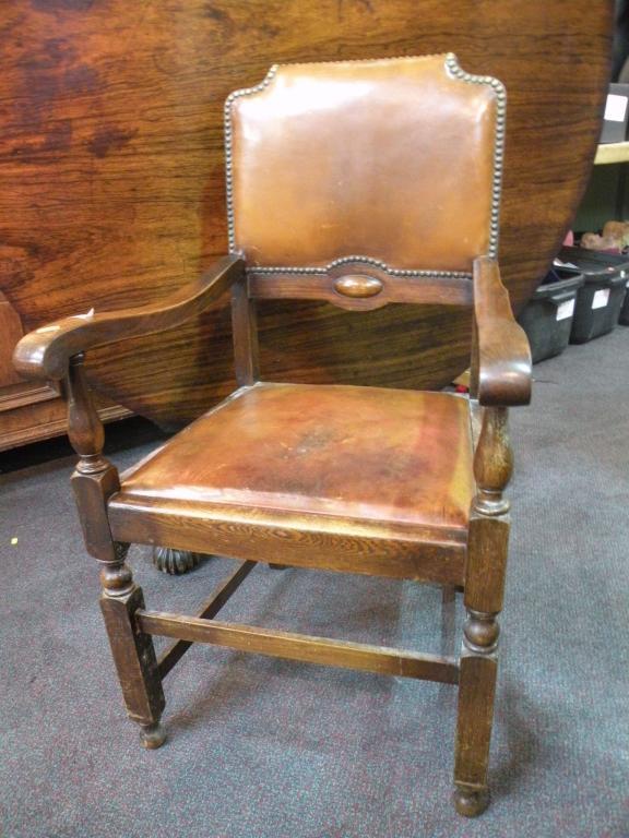 Appraisal: An oak open armchair with a leather padded back and