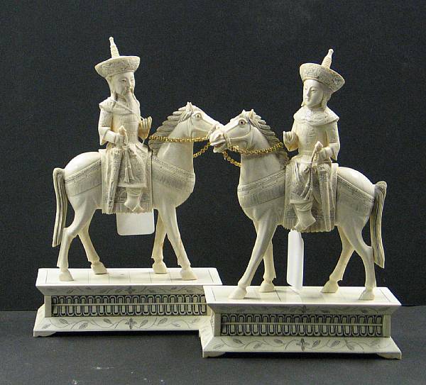 Appraisal: A pair of pieced and tinted ivory figures of an