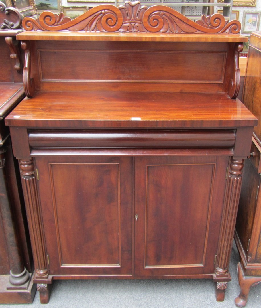 Appraisal: An early th century mahogany chiffonier with ledge back cushion