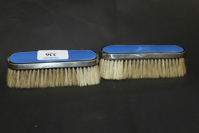 Appraisal: A PAIR OF SMALL SILVER MOUNTED CLOTHES BRUSHES with blue