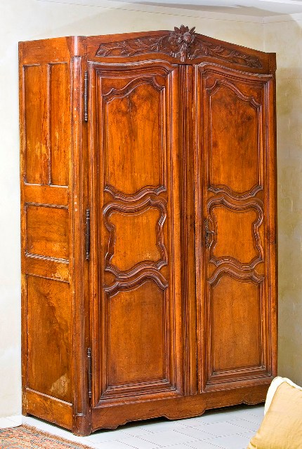 Appraisal: A provincial Louis XV period walnut armoire the top with