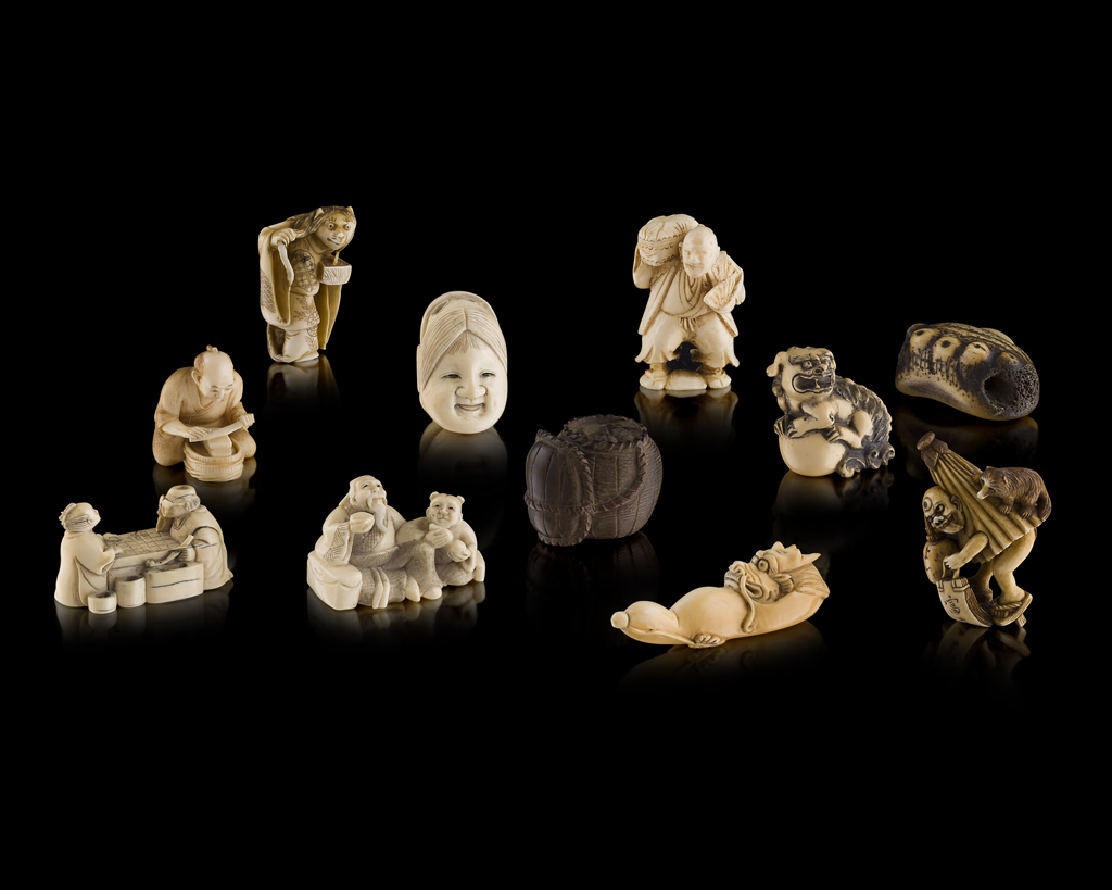 Appraisal: YGROUP OF CARVED IVORY BONE AND WOOD NETSUKES MEIJI PERIOD