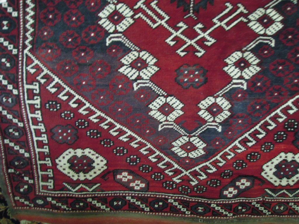 Appraisal: A Turkish carpet with a central lozenge shaped medallion interspersed