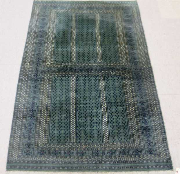 Appraisal: HAND KNOTTED ORIENTAL AREA RUG Turkoman design on green ground