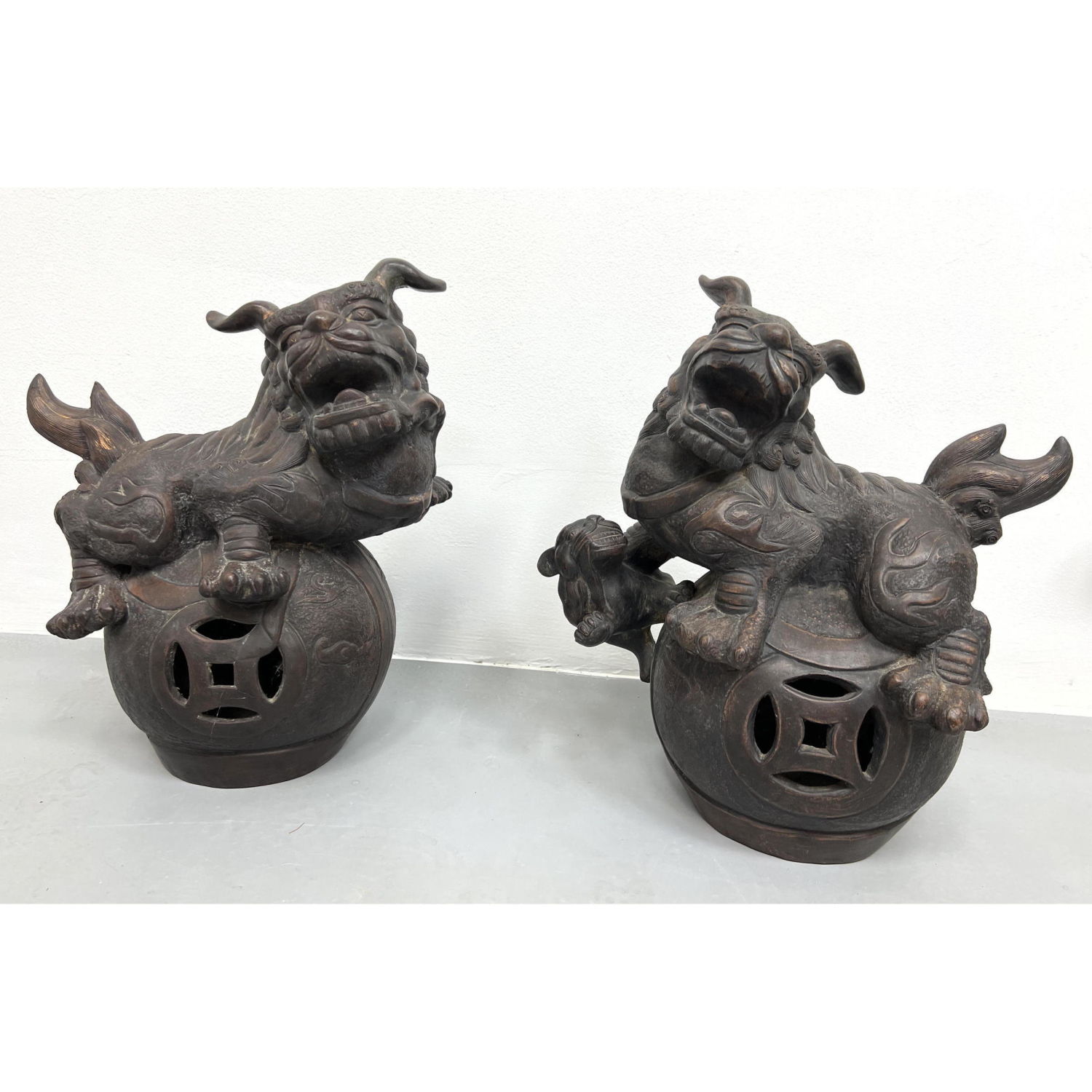 Appraisal: Pair Chinese Terra-cotta Foo Dog Garden Sculptures Bronze finish Dimensions