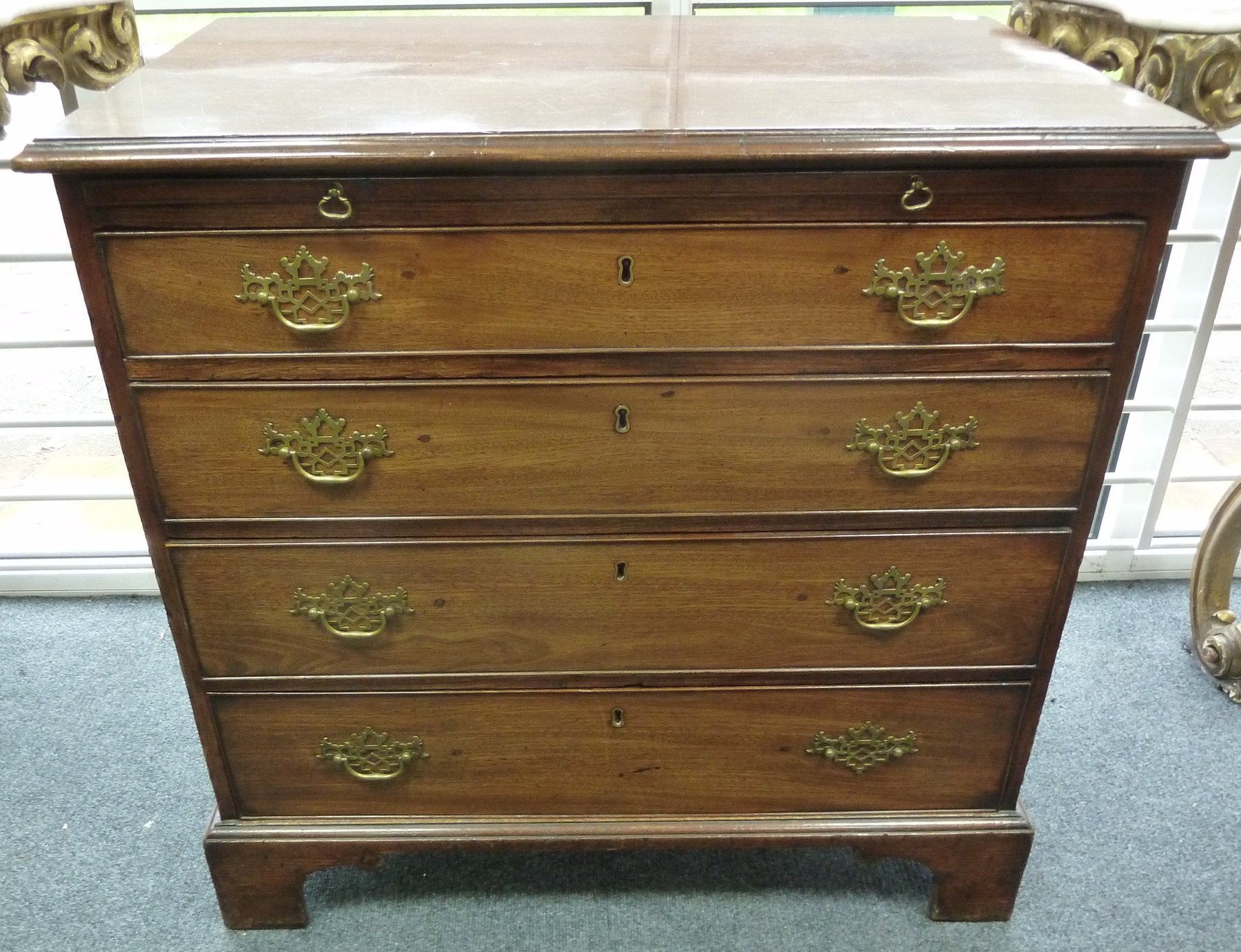 Appraisal: An early th Century mahogany chest with brushing slide over