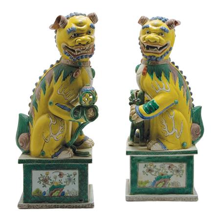 Appraisal: Pair of Chinese Yellow Glazed Foo Dogs on Stands Estimate