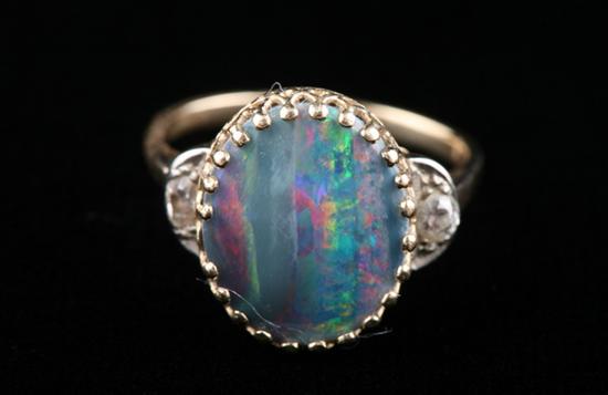 Appraisal: K YELLOW GOLD BLACK OPAL AND DIAMOND RING Centered with