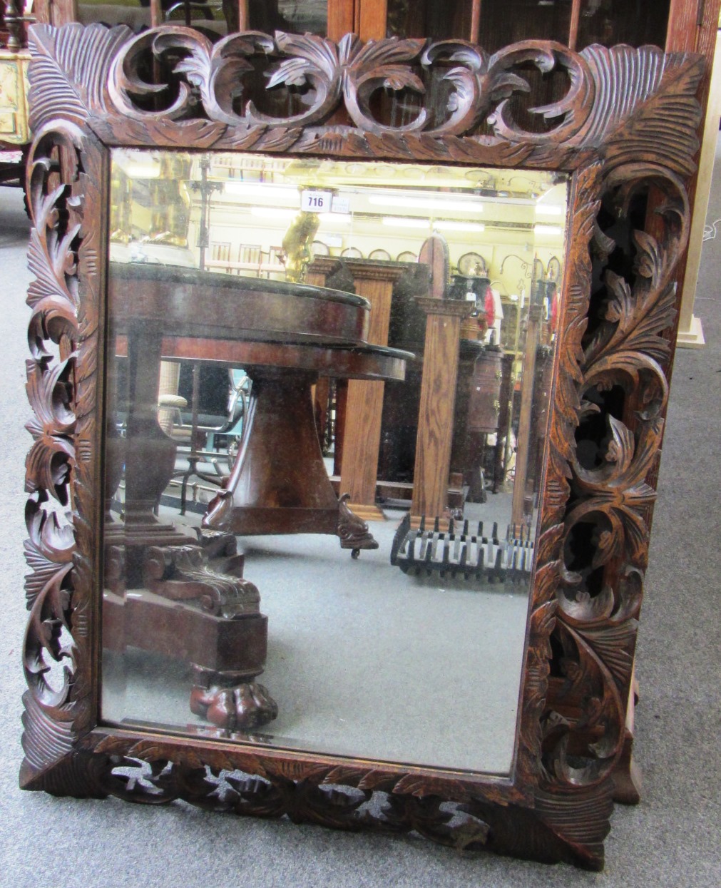 Appraisal: A th century wall mirror with swept back acanthus carved