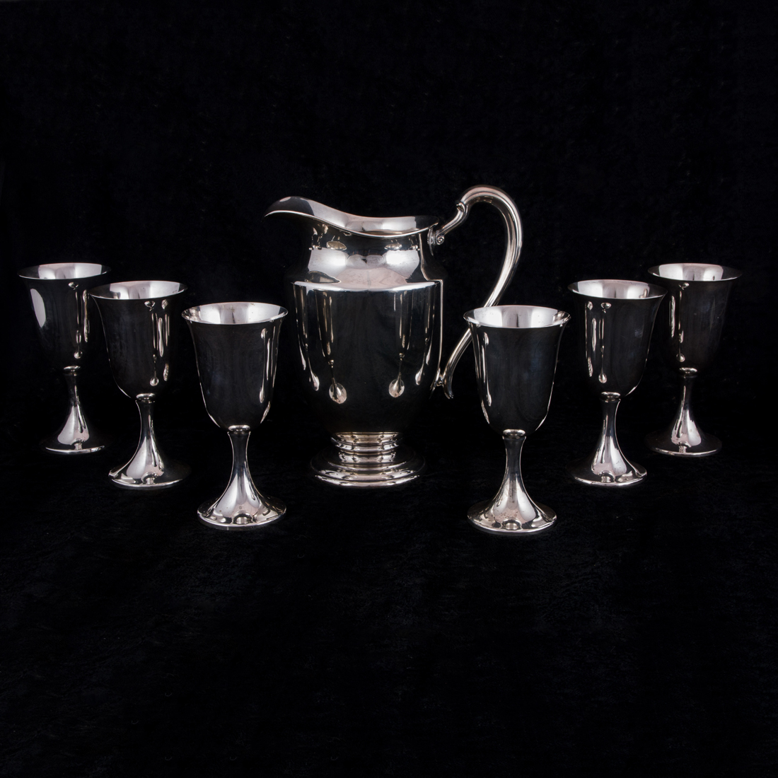 Appraisal: AN INTERNATIONAL STERLING WATER PITCHER AND SIX WATER GOBLETS An