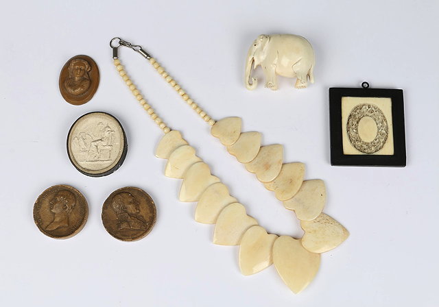 Appraisal: A BONE NECKLACE with heart shaped panel a carved ivory