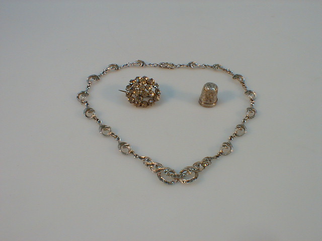 Appraisal: A Marscasite necklace diamonte brooch and a battered silver thimble