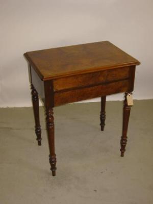 Appraisal: A CONTINENTAL WALNUT SEWING TABLE of rounded oblong form with