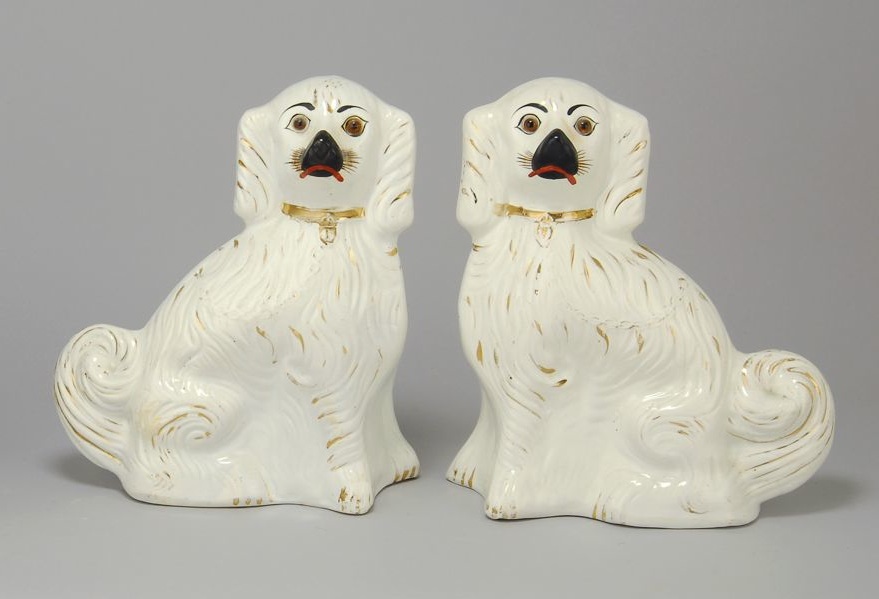 Appraisal: PAIR OF ENGLISH STAFFORDSHIRE POTTERY SPANIELS Late th CenturyIn white