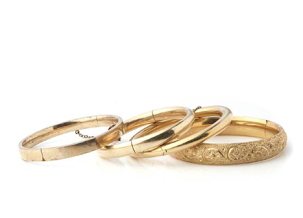 Appraisal: A collection of gold and metal bangles thee gold filled