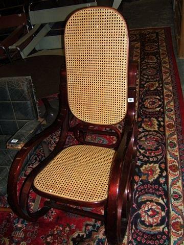 Appraisal: A bentwood rocking chair with caned back and seat