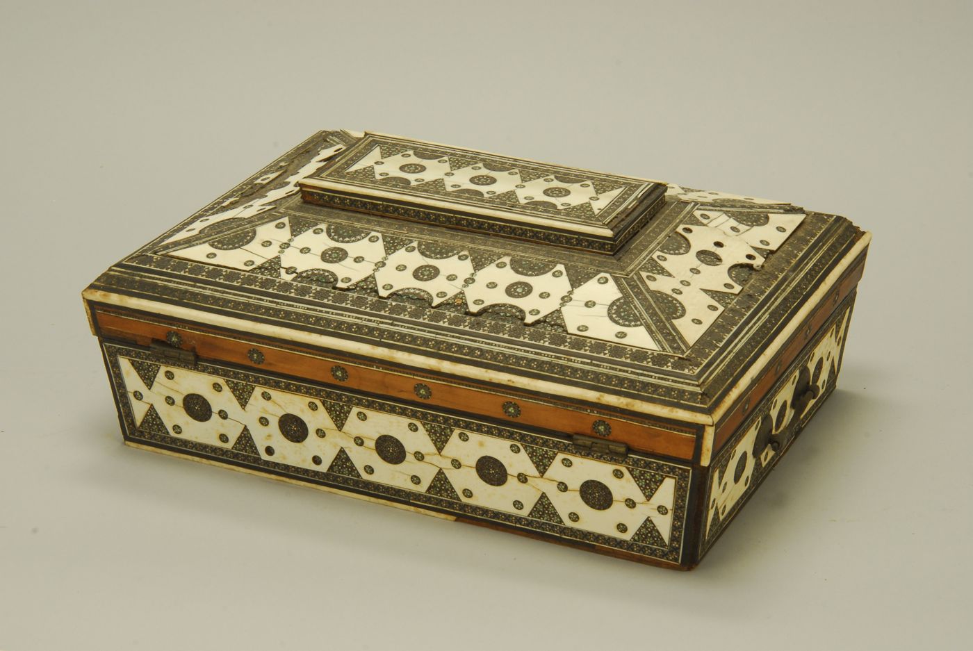 Appraisal: ANGLO-INDIAN WOOD AND IVORY LIFT-TOP BOX In exotic wood Compartmented