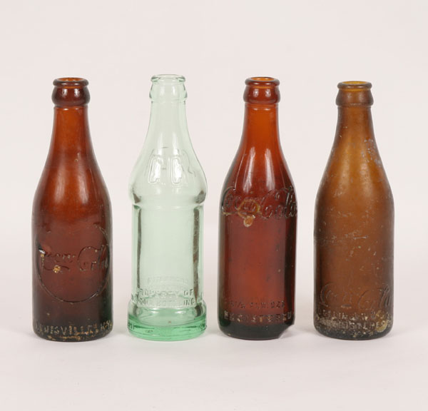 Appraisal: Three molded amber Coke bottles Lexington KY rare center shield