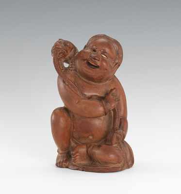 Appraisal: Carved Boy with Mythical Pet Carved boxwood possibly seated boy