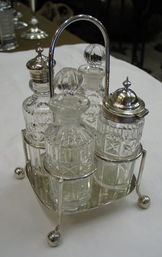 Appraisal: A -BOTTLE CASTOR SET AND AN AMERICAN CUT CRYSTAL WATER