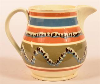 Appraisal: Earthworm Mocha Decorated China Pitcher Double earthworm bands on olive