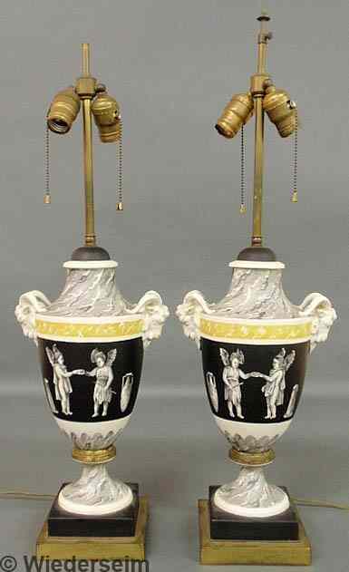 Appraisal: Pair of porcelain urn-form table lamps with ram's head mask