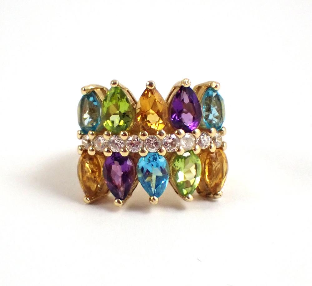 Appraisal: MULTI-COLOR GEMSTONE AND FOURTEEN KARAT GOLD RING The wide yellow