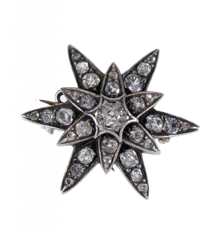 Appraisal: AN ANTIQUE DIAMOND STAR BROOCH mounted in silver and gold