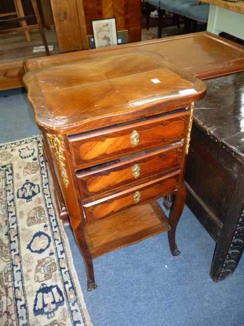 Appraisal: A CONTINENTAL KING WOOD BEDSIDE CABINET with shaped quarter veneered