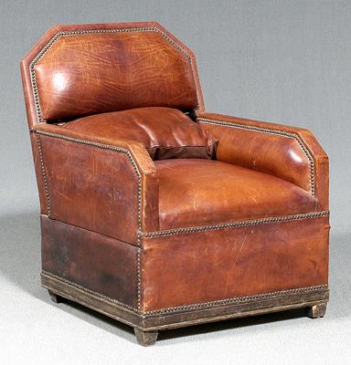 Appraisal: Art Deco club chair leather upholstered overall with brass tacks