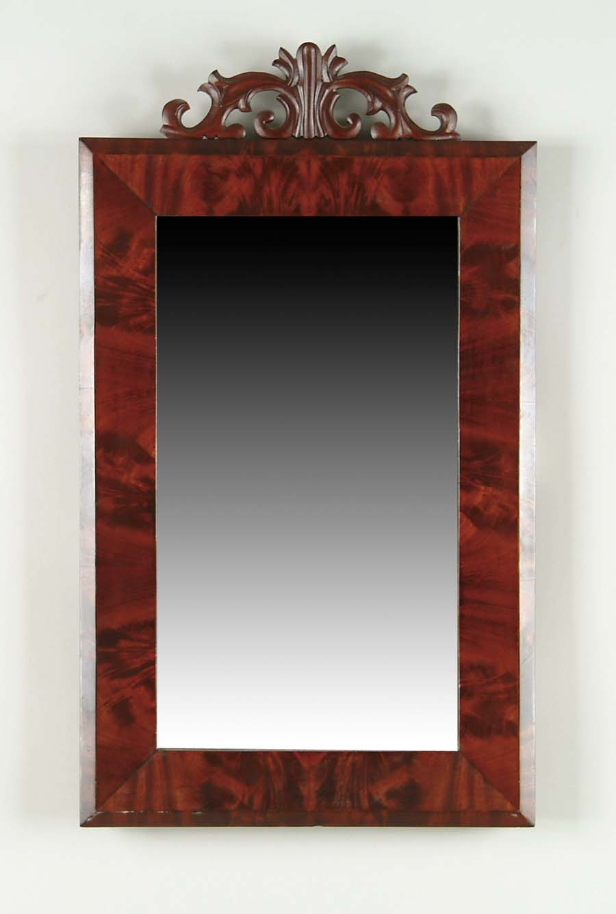 Appraisal: MAHOGANY EMPIRE MIRROR WITH CARVED CREST Nice mahogany veneers with