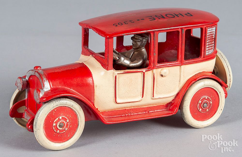 Appraisal: Arcade cast iron sedan with driver Arcade cast iron sedan