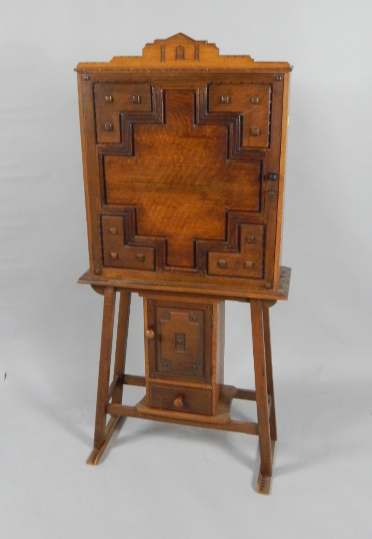 Appraisal: An early thC oak cupboard on stand the panelled door