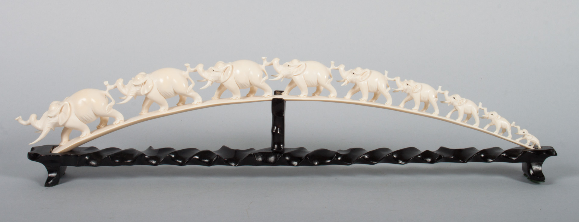 Appraisal: African carved ivory elephant bridge procession of nine elephants in